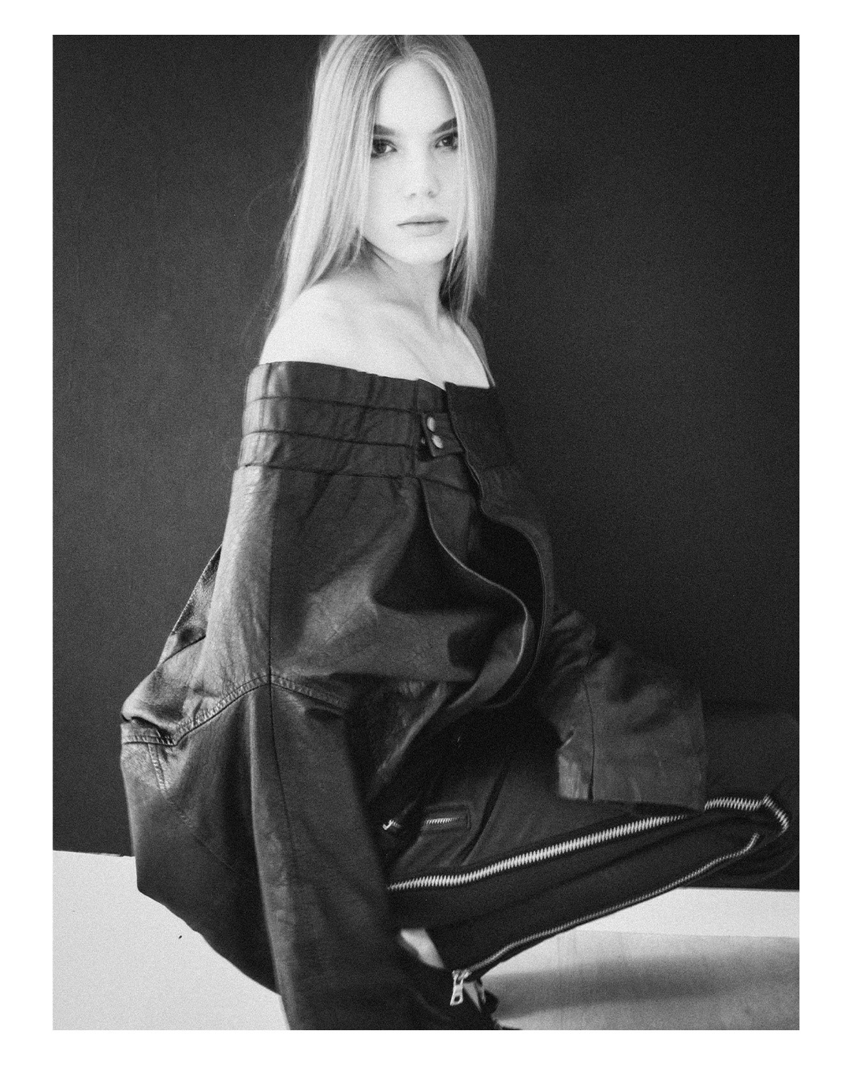 Studio editorial photography — monochrome portrait of a model in an oversized leather jacket, directed and styled by Lauren for Maison Division