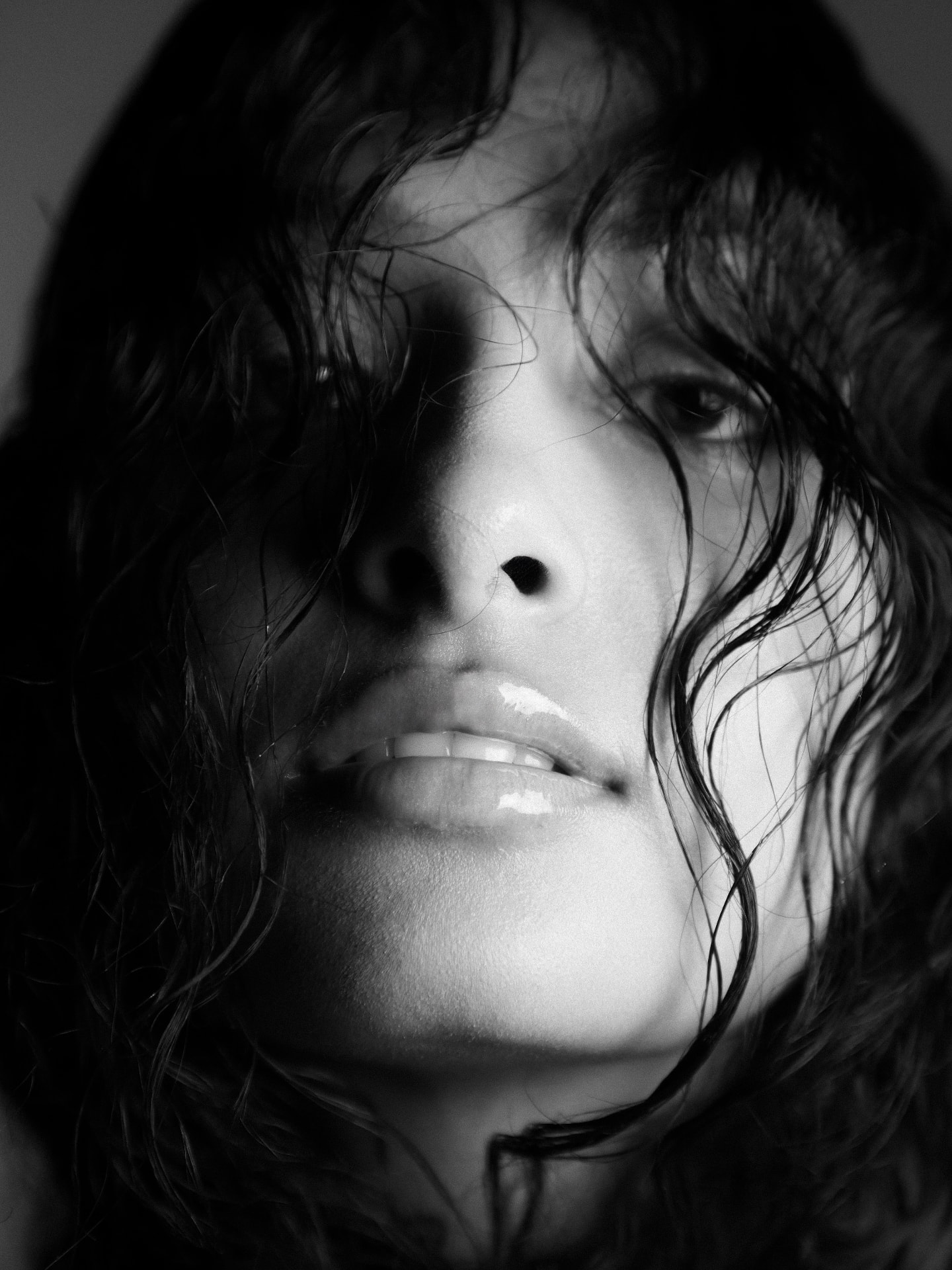 Black and white beauty portrait photography — close-up with wet hair and hard directional light, monochrome portrait shoot by Maison Division